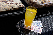 Kuna (HRK) (Croatian currency) and glass of orange juice